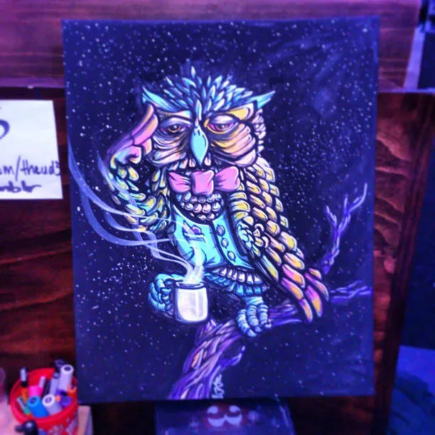 Psychedelic painting of an owl in a vest and bowtie holding a steaming mug on a branch against a starry sky