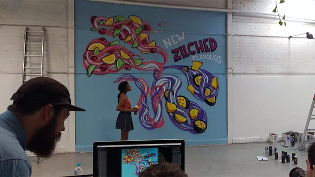 Art Director checking photos during photoshoot for Slurpee mural time-lapse with Sam Shennan