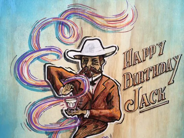Mural of a man in a hat holding a cup with psychedelic swirls and 'Happy Birthday Jack' text