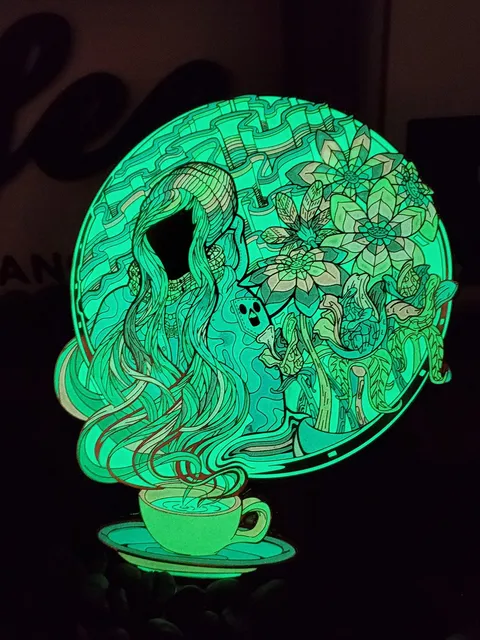 Glow-in-the-dark enamel pin of coffee cup steam forming a faceless figure in a beanie beside psychedelic flowers
