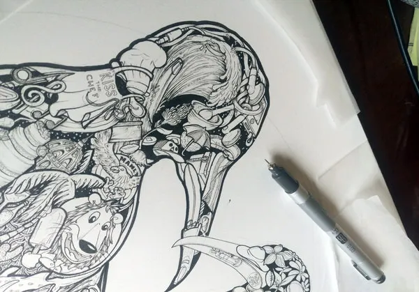 Intricate black ink drawing of a bird silhouette filled with hidden objects and doodles, with a pen resting on the paper