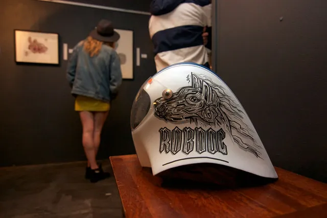 Custom painted white helmet featuring a bold black line drawing of a stylized dog head and the word ROBDOG