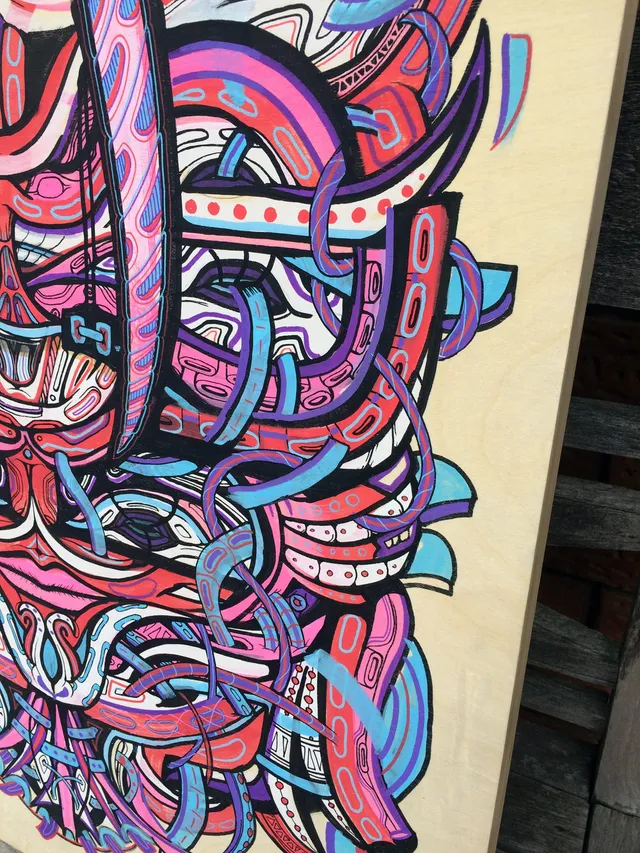 Close-up of a psychedelic painting on wood featuring intertwined pink, blue, and purple shapes with bold black outlines