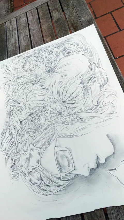 Pencil drawing on paper of a profile face with glasses, surrounded by intricate, flowing psychedelic line work
