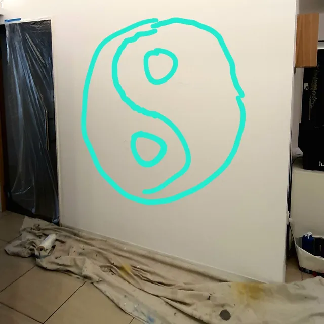 Mural in progress showing a rough cyan outline of a yin-yang symbol on a white wall