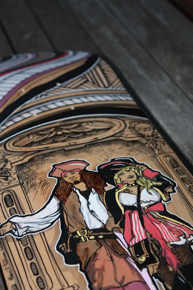 Hand-painted skateboard depicting a pirate couple with bold white outlines against intricate architectural linework
