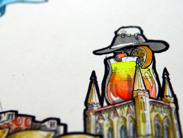 Ink drawing of a tropical cocktail with an orange slice wearing a wide-brimmed hat atop a gothic building