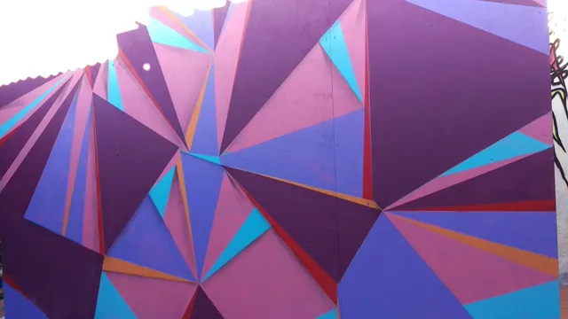 Abstract geometric mural featuring intersecting triangles in shades of purple, pink and blue
