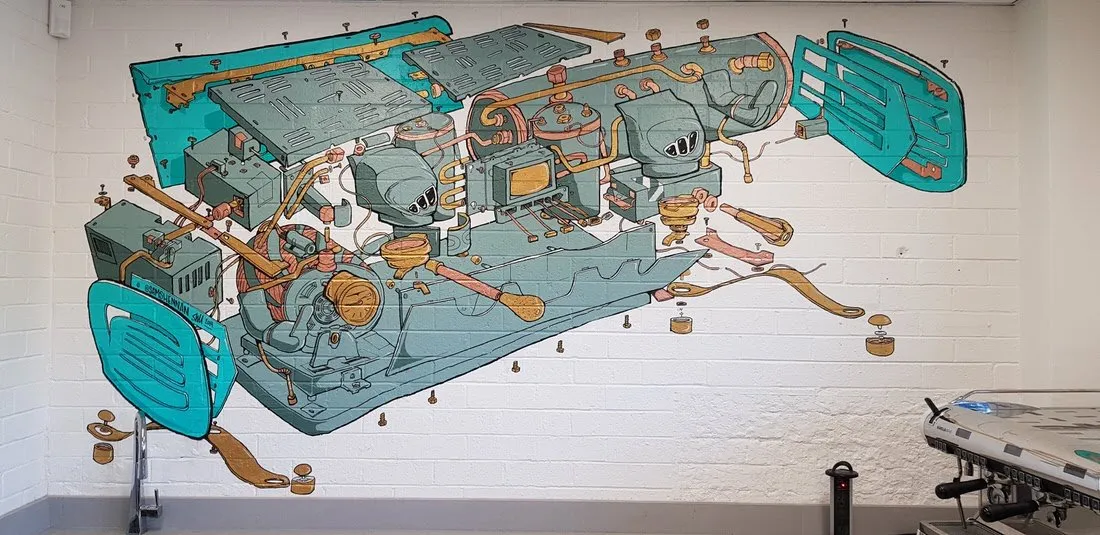 Mural on a white brick wall showing an exploded technical diagram of a teal and copper espresso machine