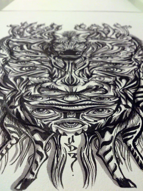 Black ink drawing of a symmetrical psychedelic zebra mask featuring bold line work and multiple eyes