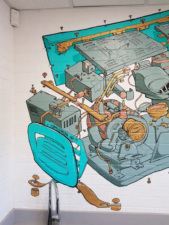 Mural on a white brick wall showing an exploded view of espresso machine parts in teal and copper