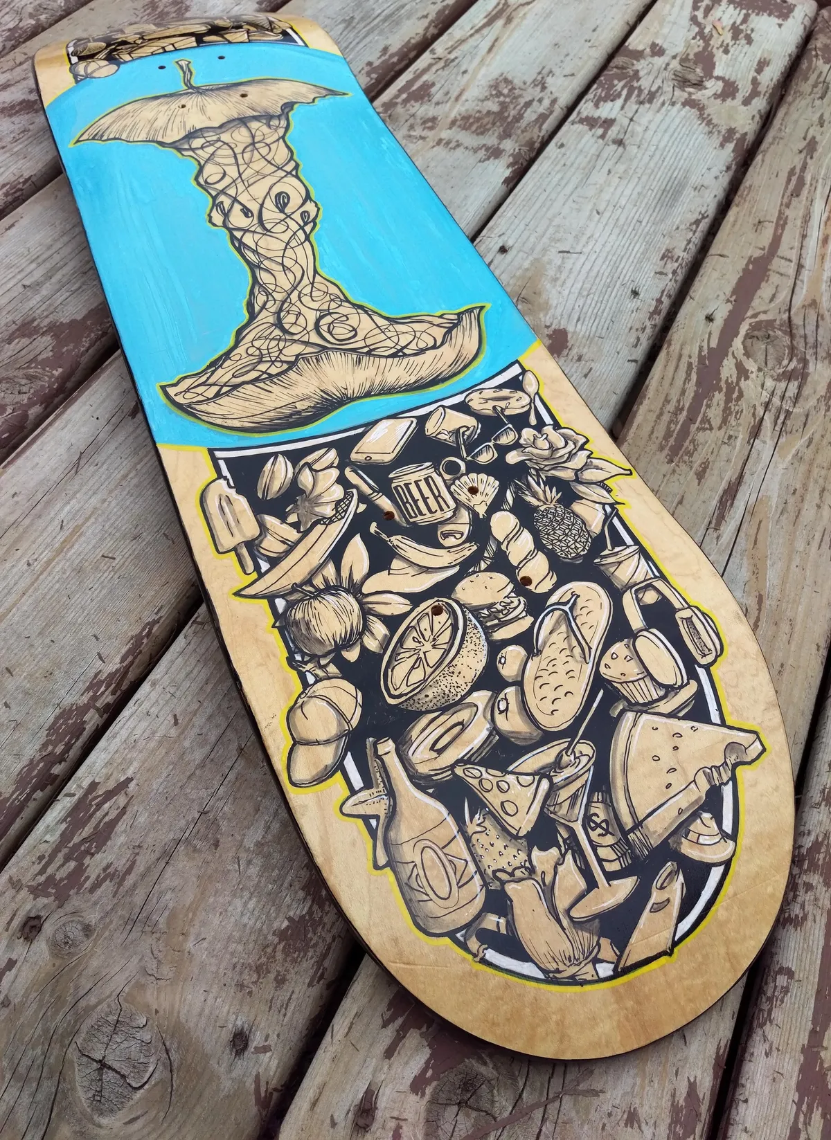 Hand-painted skateboard deck featuring a swirling apple core on blue above a dense ink doodle of food and summer objects