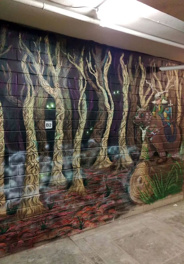 Glowing eyes in trees interior forest mural