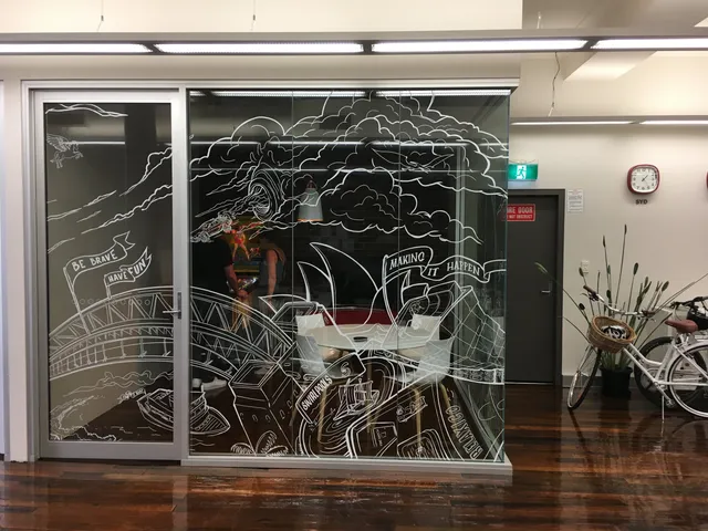 White line art mural on a glass office wall depicting a Sydney cityscape with the Harbour Bridge and Opera House