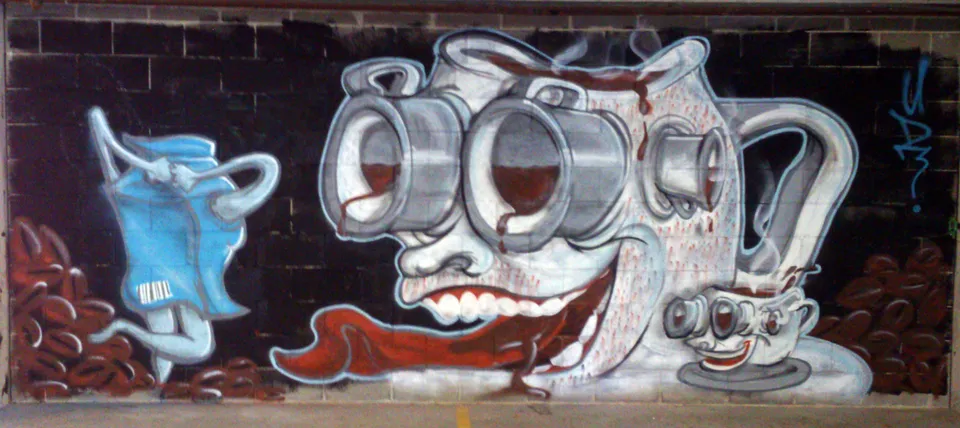 Aerosol mural of a grinning coffee pot with coffee cup eyes, dripping coffee, a running milk carton, and coffee beans