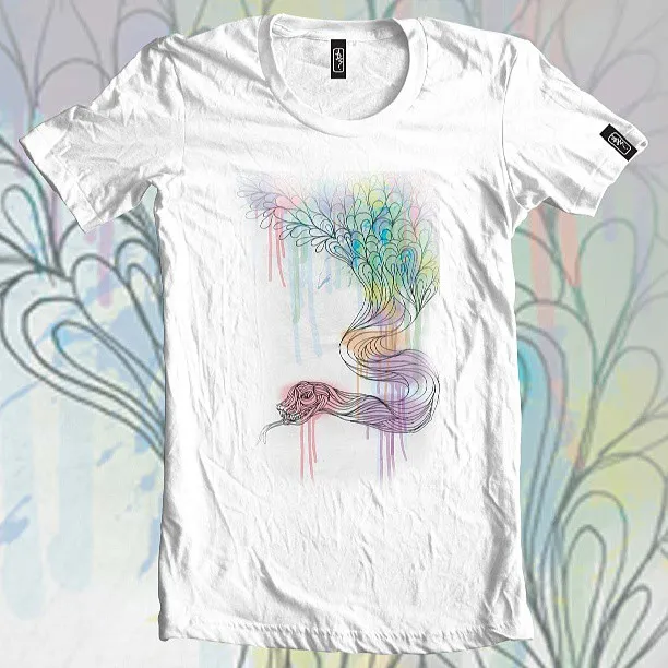 White t-shirt featuring a psychedelic illustration of a snake with a feathered tail and pastel watercolor drips