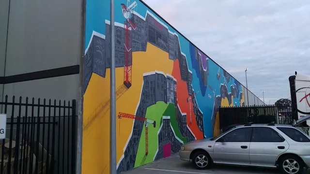 Finished mural towering over car