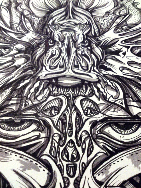 Close-up black and white ink drawing of a symmetrical, totemic lionfish shaman face with multiple eyes and bold lines