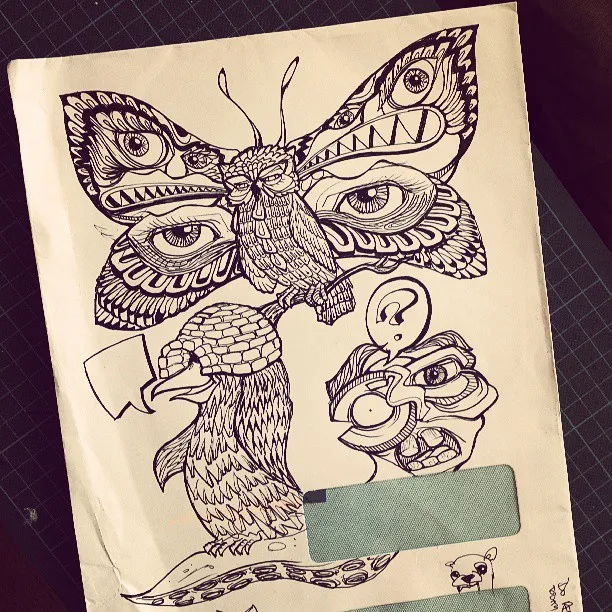 Ink drawing on an envelope of a surreal owl with butterfly wings, a helmeted bird, and a distorted face
