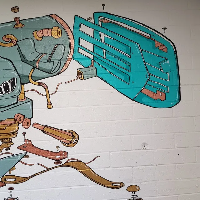 Mural on white brick depicting an exploded view of a teal and bronze machine with floating panels and screws