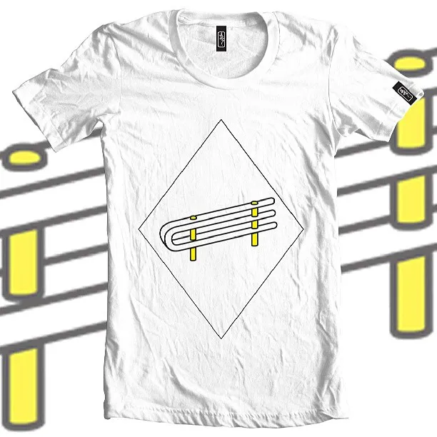 White t-shirt featuring a graphic of a yellow and white street barrier inside a diamond outline