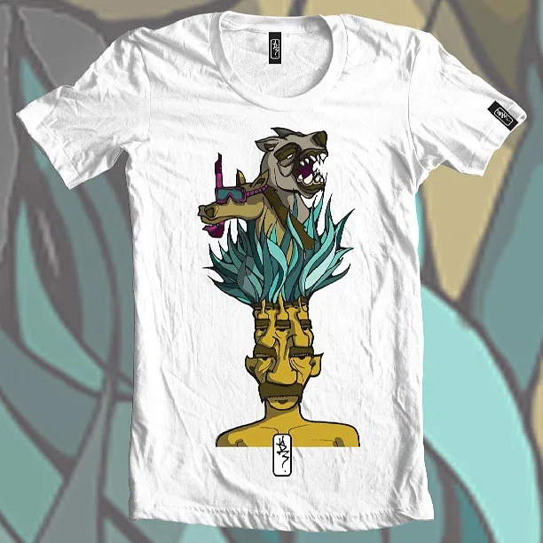White t-shirt with a surreal illustration of a multi-eyed totem face sprouting leaves, a hyena, and a snorkeling horse