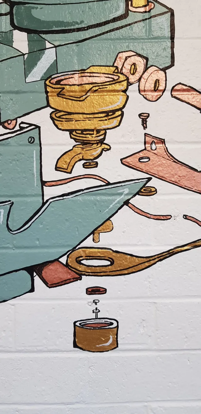 Mural detail on white brick depicting an exploded diagram of espresso machine parts painted in teal and gold