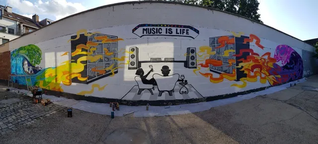 Outdoor mural of silhouettes listening to a stereo below a MUSIC IS LIFE banner, flanked by colorful psychedelic waves