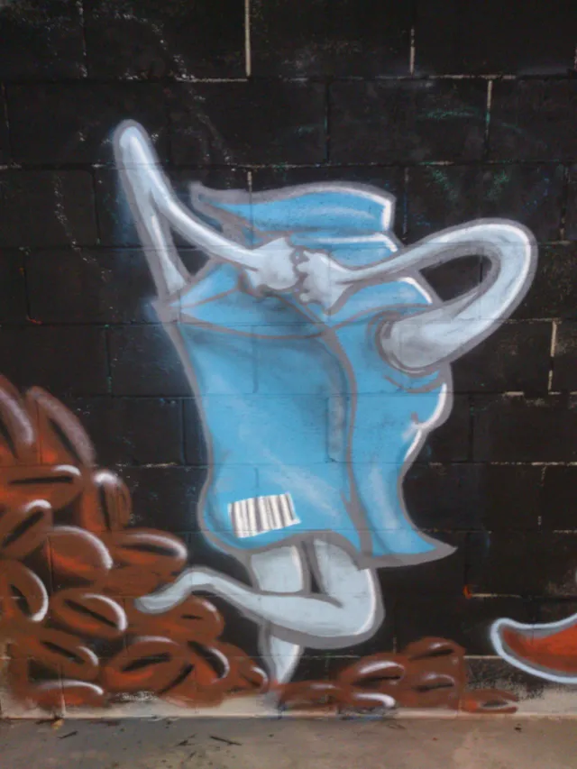 Mural of an anthropomorphic blue coffee bag character with a barcode standing next to a pile of coffee beans