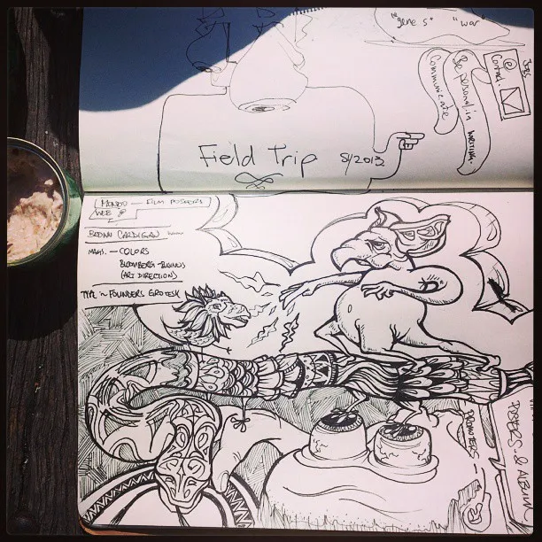 Open sketchbook showing an ink drawing of a patterned snake, whimsical creatures, and handwritten notes
