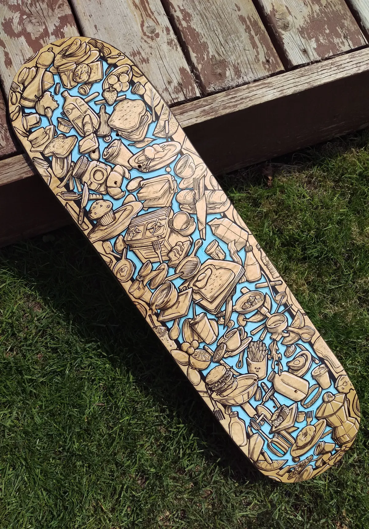 Painted skateboard deck featuring a dense bold line drawing of food, drinks, and utensils on a light blue background