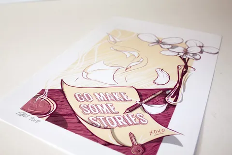 Printed illustration of a scroll reading Go Make Some Stories, a pencil, key, flowers, and a skull coffee cup