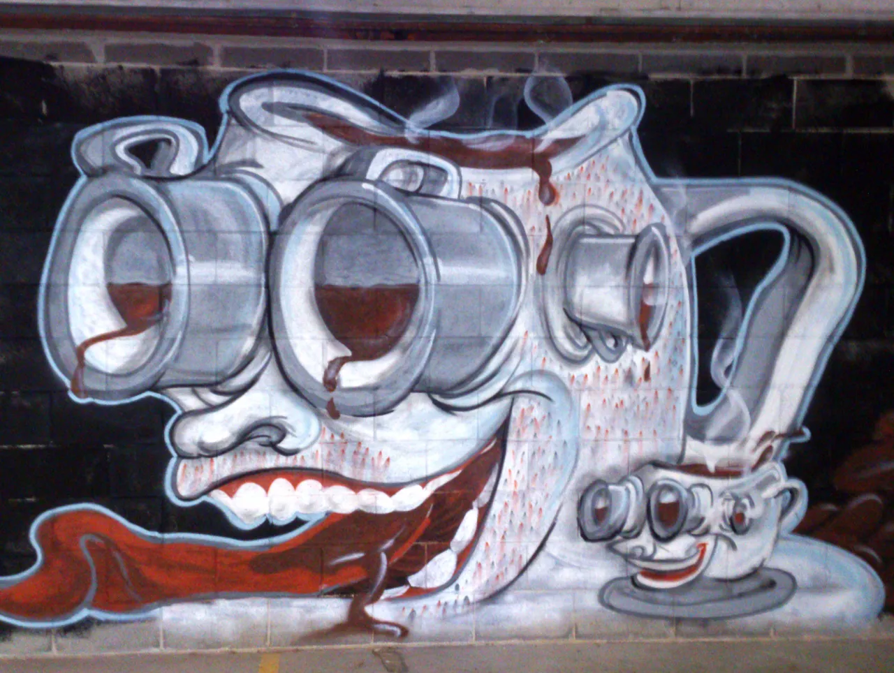 Mural of a grinning coffee pot with large, dripping eyes, long red tongue, and a small smiling coffee cup