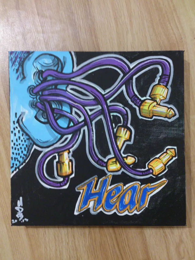 Canvas painting of a blue ear with purple audio cables plugging into it and the word Hear