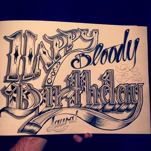 Ink drawing of ornate, shaded hand-lettering on paper reading Happy Bloody Birthday Laura!