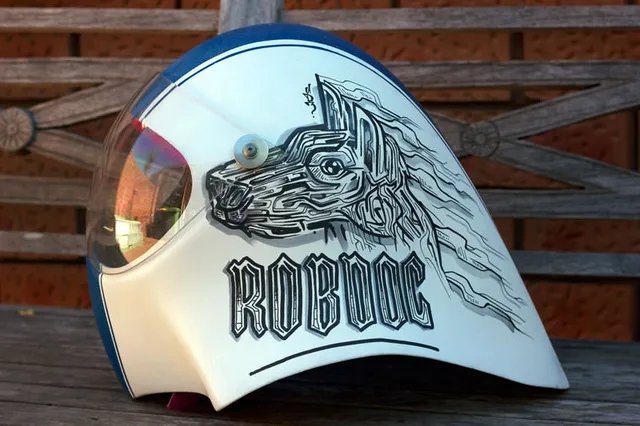 Custom painted helmet featuring a stylized dog head in bold black linework above the text ROBDOG