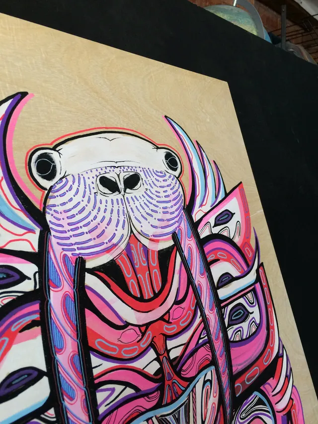 Psychedelic painting of a totemic walrus mask with bold lines in bright pink and purple on a wooden panel