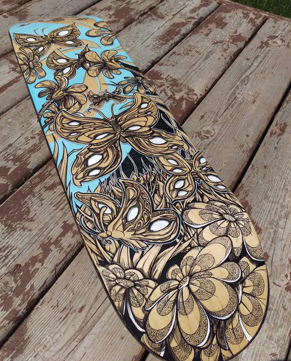 Closeup of  work in process hand painted skateboard custom graphic.