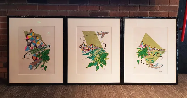 Three framed graphic illustrations of colorful geometric mountains, tropical leaves, a train, airplane, and boat