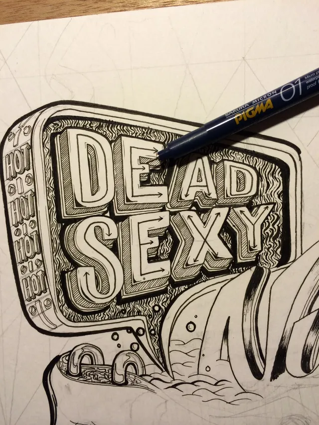 Ink drawing of 3D lettering spelling DEAD SEXY inside a speech bubble, with a fineliner pen resting on the artwork