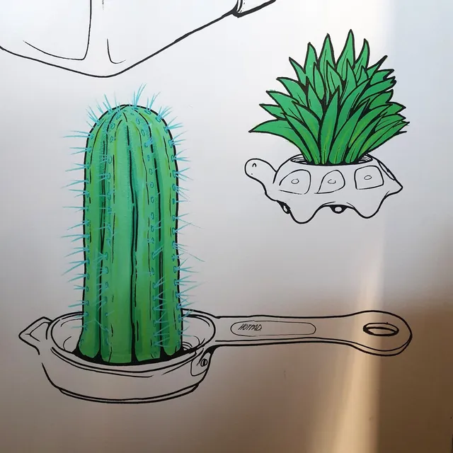 Mural of a green cactus in a frying pan and a spiky plant in a turtle-shaped pot, drawn with bold black outlines