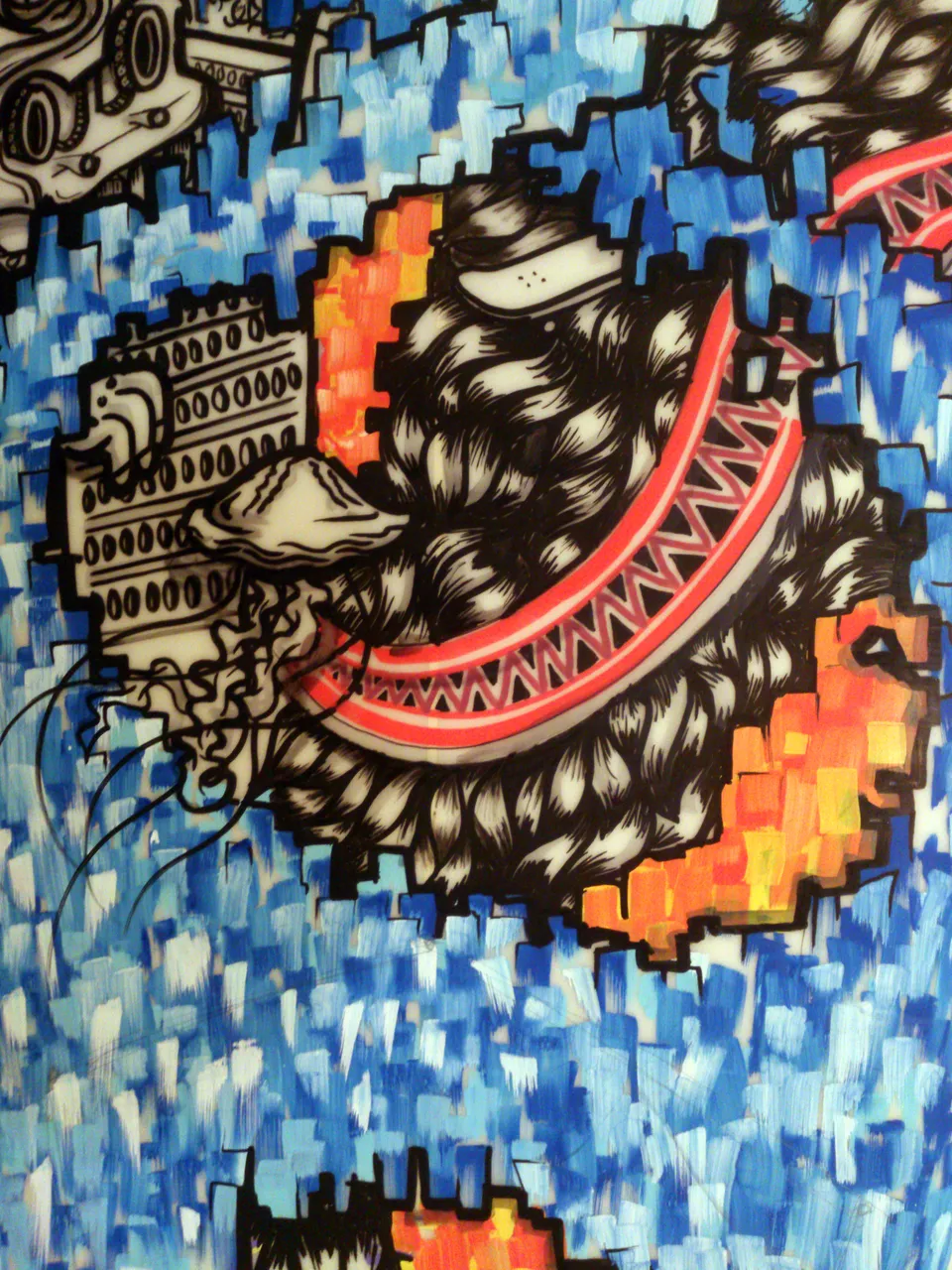 Surfboard painting detail with a jellyfish, geometric structure, and jagged red shape against a blue mosaic background