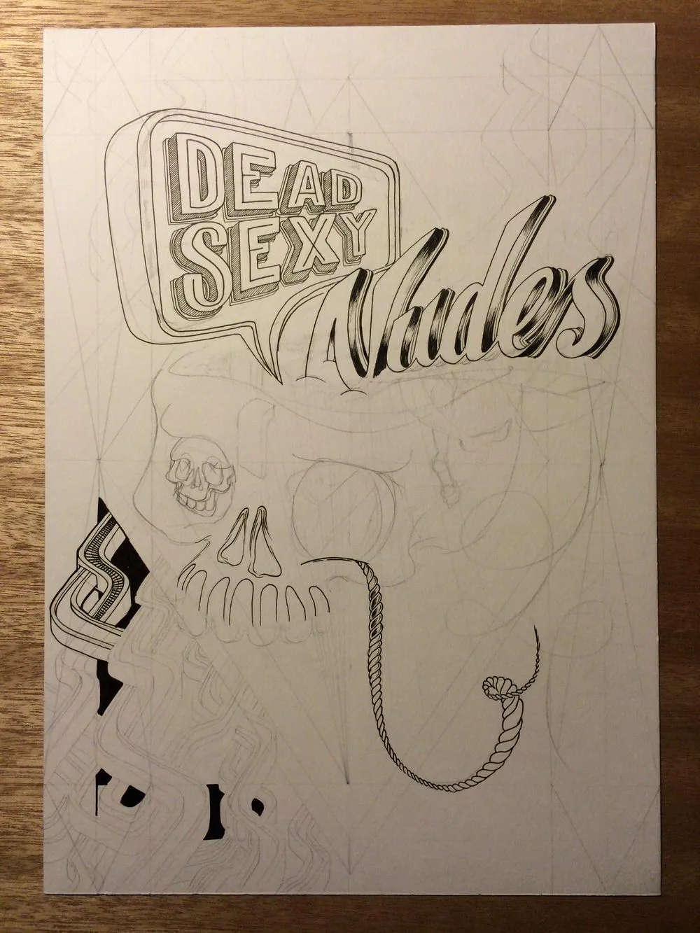 Ink and pencil drawing in progress of a skull with stylized text reading DEAD SEXY Nudes