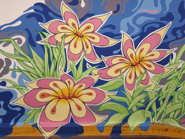 Mural featuring three symmetrical pink and yellow flowers with green leaves against a wavy blue background