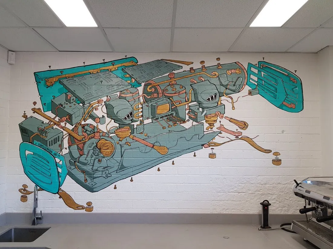 Mural on a white brick wall showing an exploded-view diagram of an espresso machine with teal panels and copper pipes