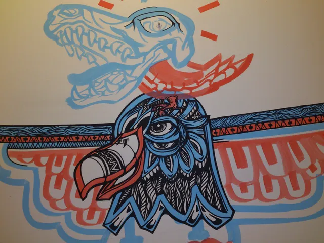 Mural of a totemic bird head in bold black, red and blue patterns beneath a light blue outline of an animal skull