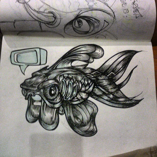 Sketchbook ink drawing of a surreal fish with intricate line work and flowing fins next to an empty speech bubble