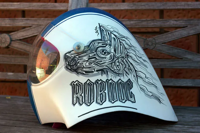 Hand-painted white helmet featuring a bold black line drawing of a stylized dog profile and the text ROBDOG