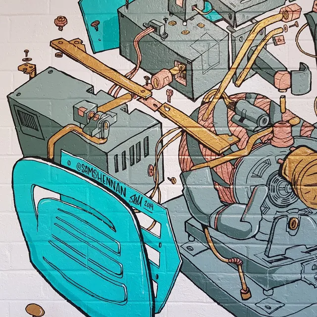 Mural on a white brick wall depicting an exploded view of machinery with a motor, copper coils, and teal casing