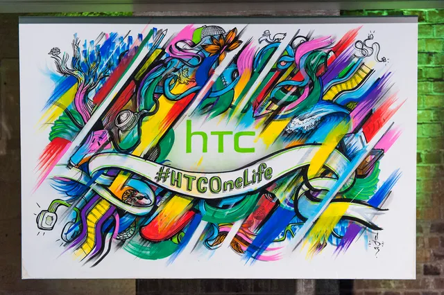 Vibrant canvas painting featuring the HTC logo and #HTCOneLife banner surrounded by dynamic, colorful illustrations